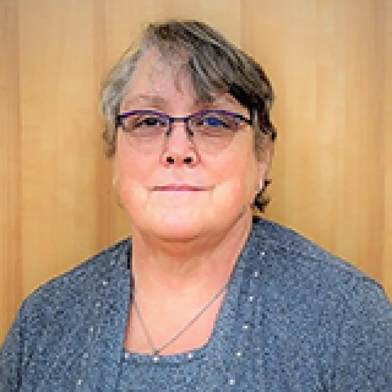 Headshot of a woman with short hair who is wearing glasses.